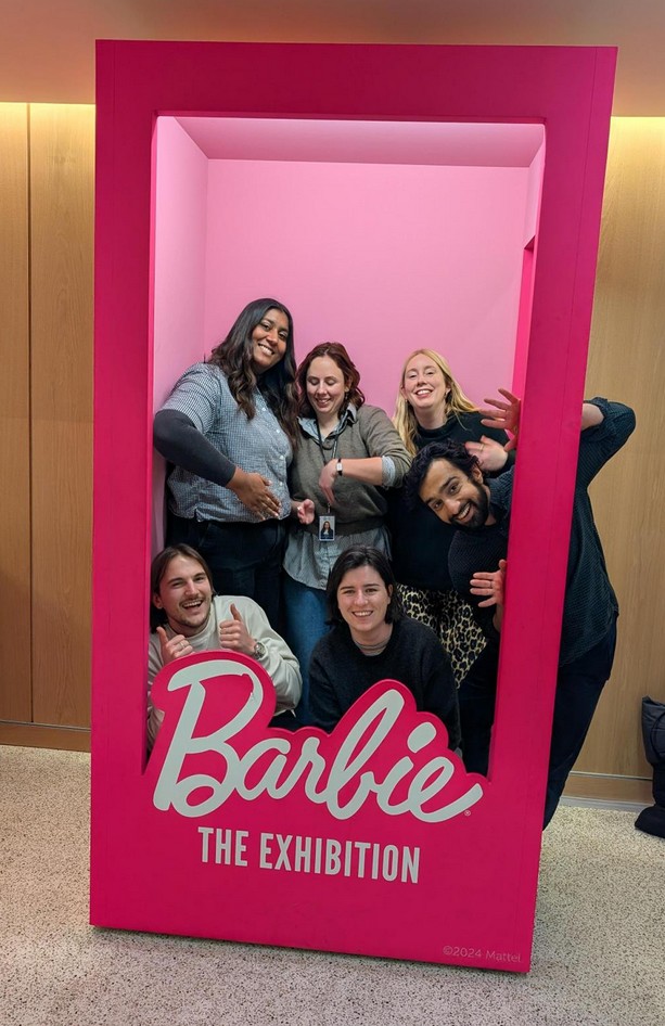 The UX team posing inside a giant Barbie box at Barbie The Exhibition